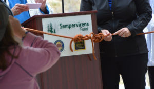 Project partners untied a climbing rope to officially open the new entrance.