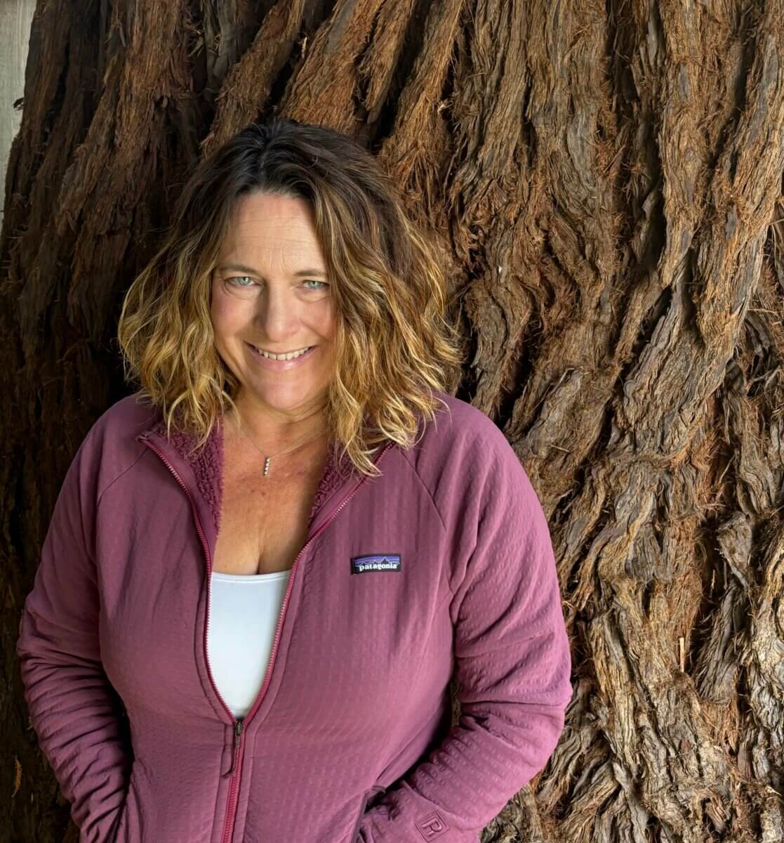 Portrait image of Sempervirens Fund's Director of Government Relations Rachel Dann standing in front of a coast redwood tree.