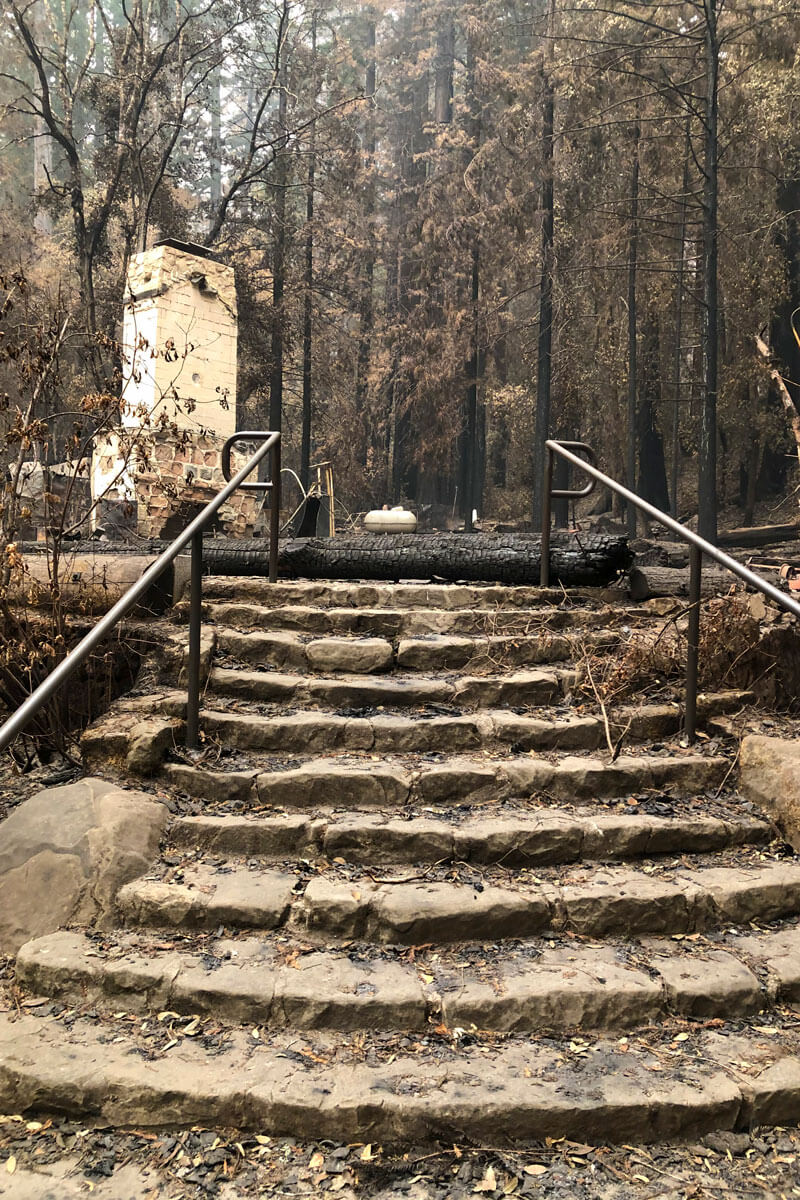 A stone stairway leads to a stone fireplace that is all that remains of Big Basin Redwoods State Park's visitor center after the 2020 CZU Fire, by Laura McLendon
