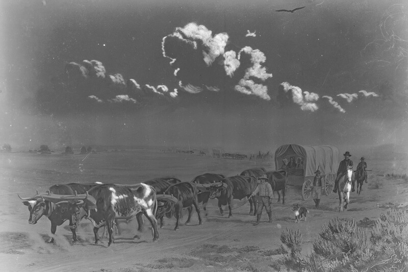 A black and white photo of a painting that depicts a covered wagon being pulled across a prairie by a team of oxen as people walk and ride horses alongside.