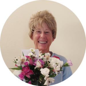 Jen Parks smiles holding a bouquet of flowers, by Michael Parks