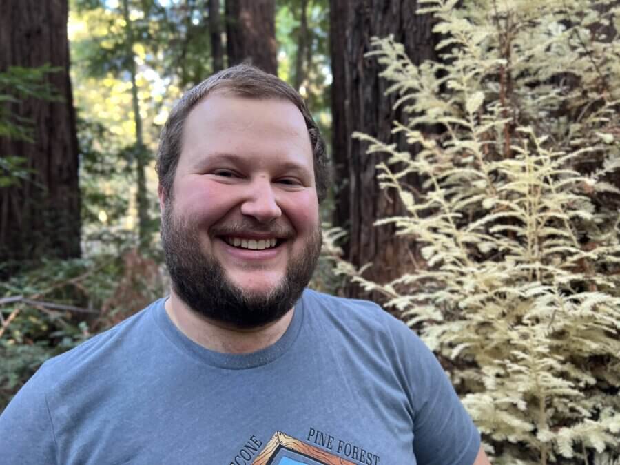 Zane Moore in the foreground, and an albino redwood in the background.