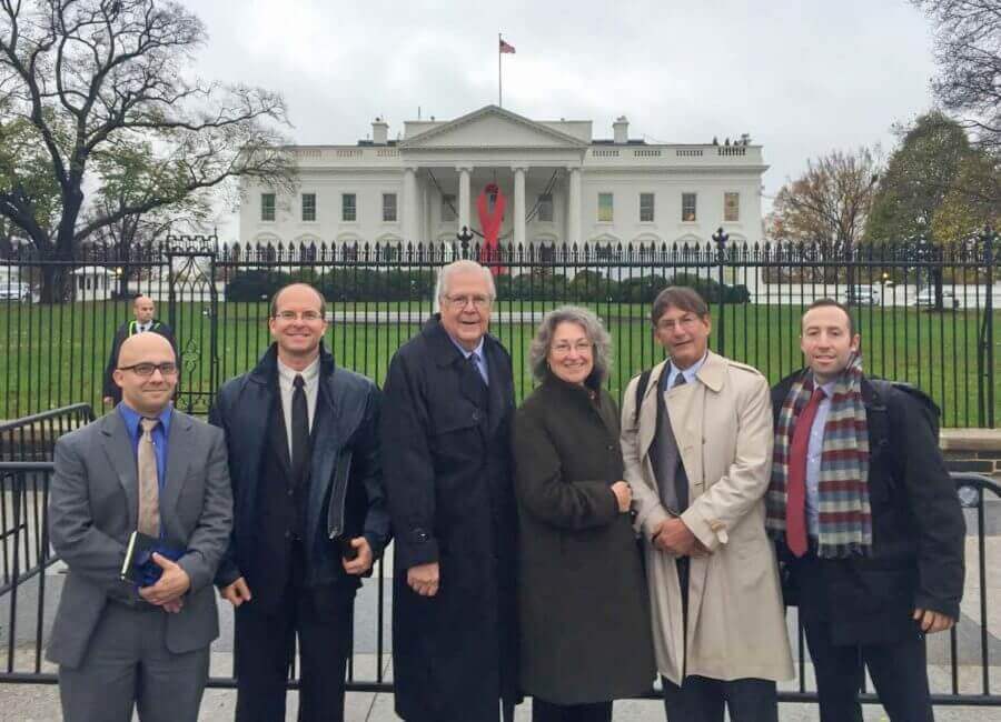 A group of people in front of the White House.