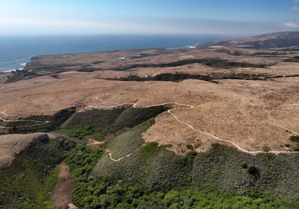 Trails crisscross Cotoni-Coast Dairies, with the Pacific Ocean in the background.