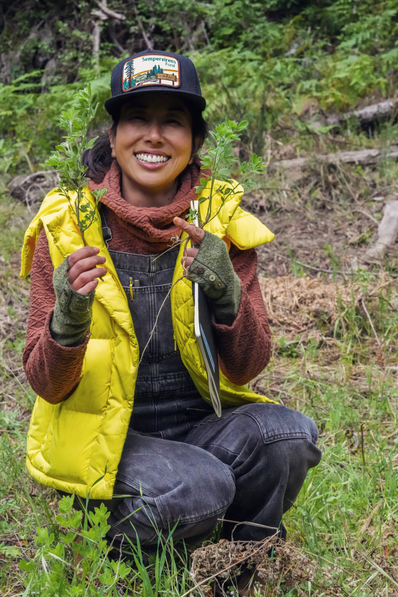 Sempervirens Fund's Forest Fellow Jane Kim helping clear the meadow of invasive French Broom.